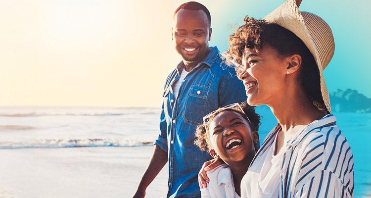 Two African American parents smiling and walking with their young daughter who is smiling as they're walking on the beach with blue gradient hovering around them 