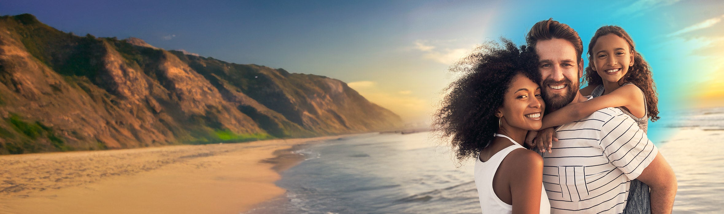 Young African American woman smiling with her Caucasian  husband and their daughter on a beautiful beach 